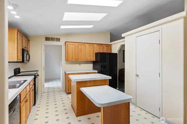 a kitchen with a stove a refrigerator and a sink