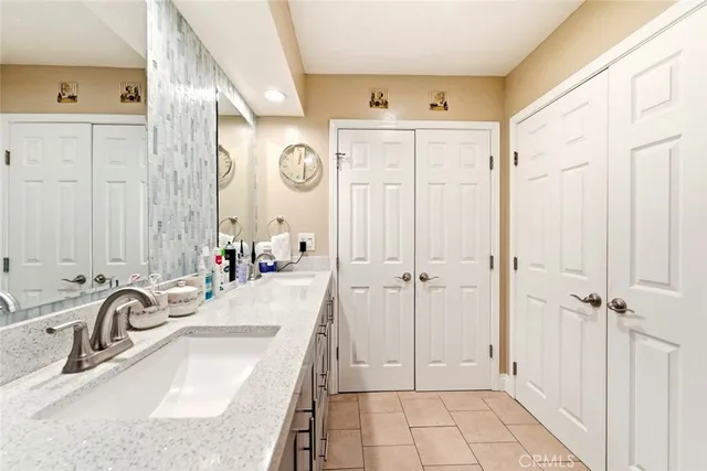a bathroom with a sink tub vanity and a mirror