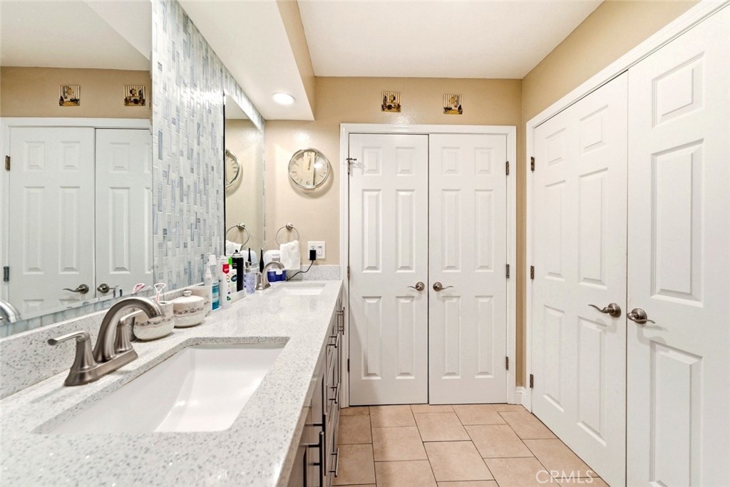 133 Colombo Lane Tustin, CA 92780 - Photo 14 of 26 a bathroom with a sink tub vanity and a mirror
