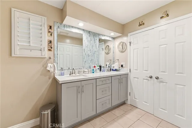 a bathroom with a double vanity sink a mirror and a shower