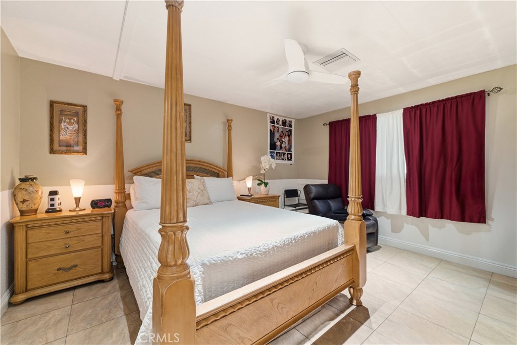 133 Colombo Lane Tustin, CA 92780 - Photo 18 of 26 a bedroom with a large bed and a chandelier