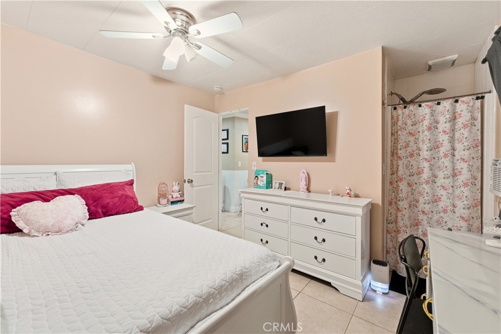 133 Colombo Lane Tustin, CA 92780 - Photo 20 of 26 a bedroom with a bed and a flat screen tv