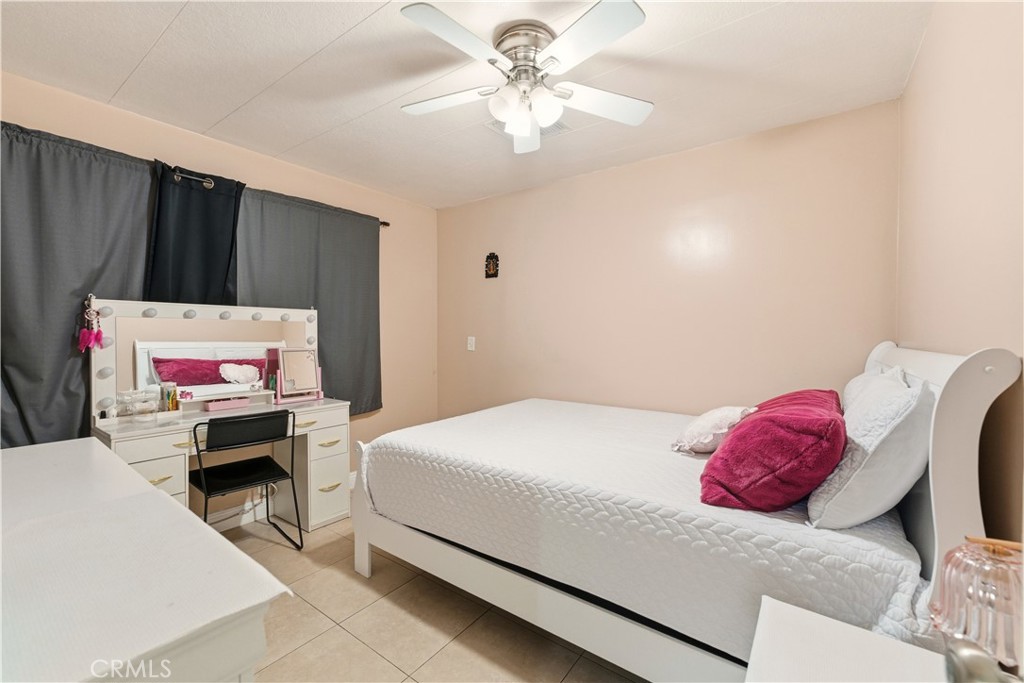 133 Colombo Lane Tustin, CA 92780 - Photo 21 of 26 a bedroom with a bed and a chandelier