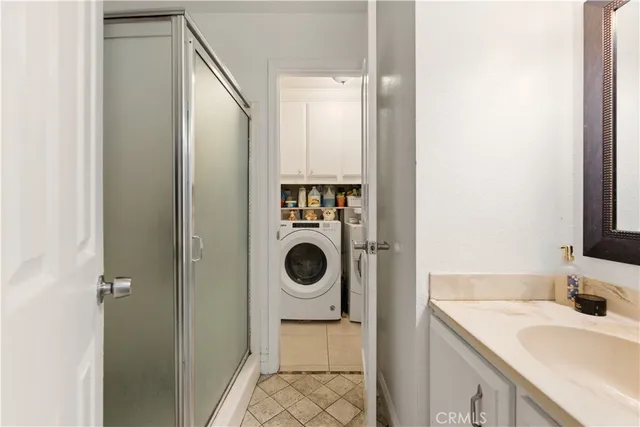 a bathroom with a granite countertop shower and a toilet