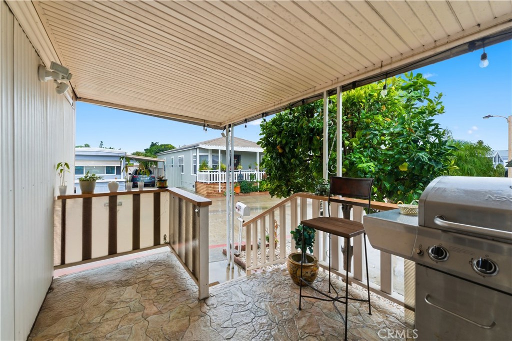 133 Colombo Lane Tustin, CA 92780 - Photo 5 of 10 a view of a patio with table and chairs with wooden floor and fence