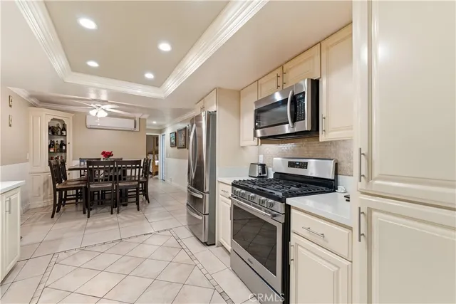 a kitchen with stainless steel appliances granite countertop a stove and a refrigerator