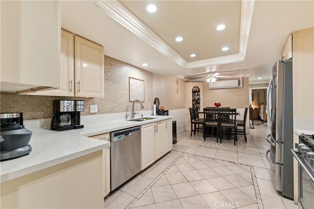 133 Colombo Lane Tustin, CA 92780 - Photo 8 of 26 a kitchen with sink cabinets and dining table chair