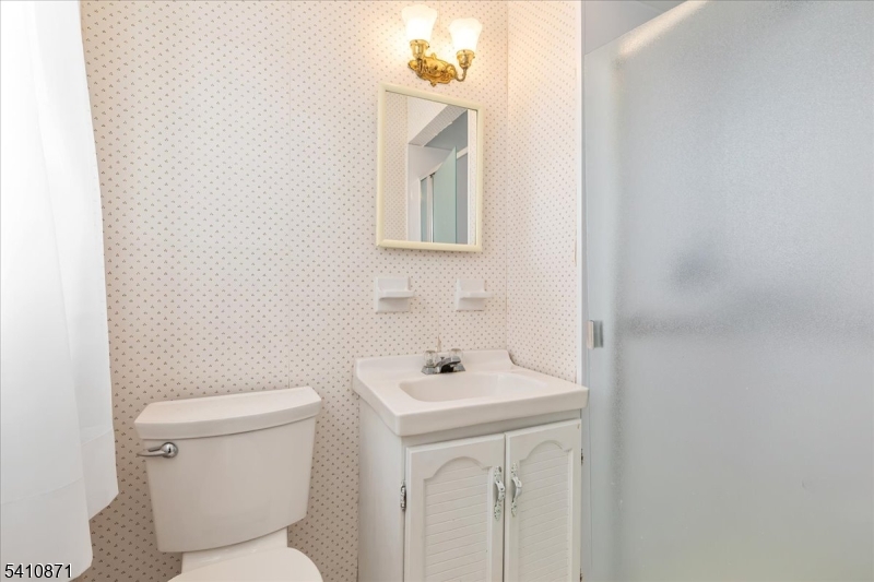 11 Dorr Road New Providence, NJ 07974 - Photo 12 of 28 a bathroom with a toilet a sink and mirror
