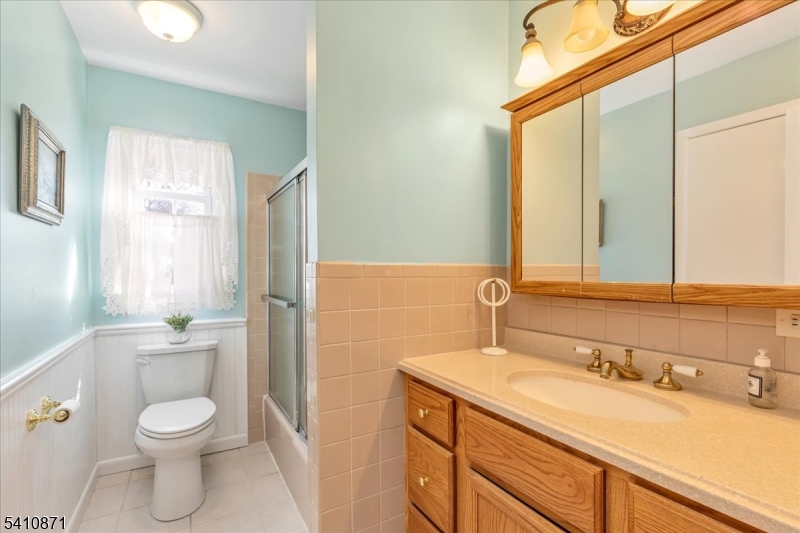 11 Dorr Road New Providence, NJ 07974 - Photo 15 of 28 a bathroom with a granite countertop toilet a sink and a mirror