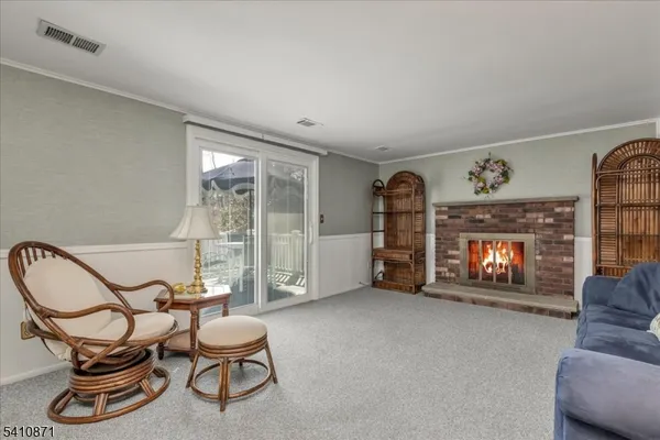 a living room with furniture gym equipment and a floor to ceiling window