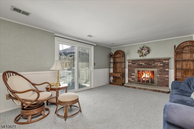 11 Dorr Road New Providence, NJ 07974 - Photo 16 of 28 a living room with furniture a fireplace and a flat screen tv