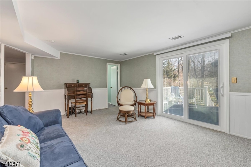 11 Dorr Road New Providence, NJ 07974 - Photo 18 of 28 a living room with furniture gym equipment and a floor to ceiling window