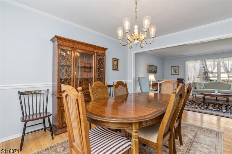 11 Dorr Road New Providence, NJ 07974 - Photo 7 of 28 a dining room with furniture a chandelier and wooden floor