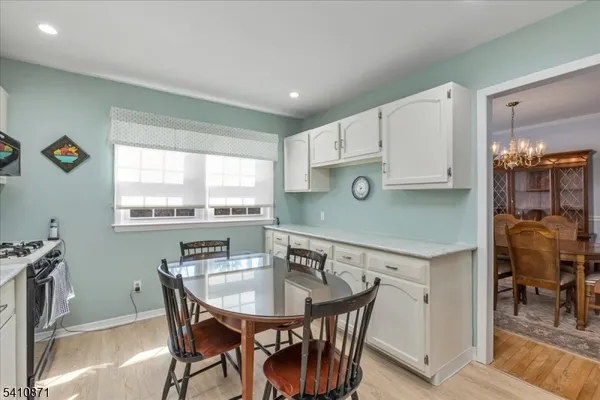 a kitchen with a table chairs and a refrigerator