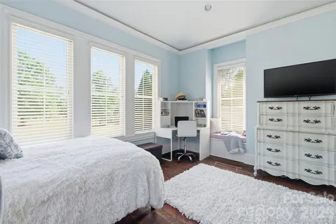 a bedroom with a bed and a flat tv screen