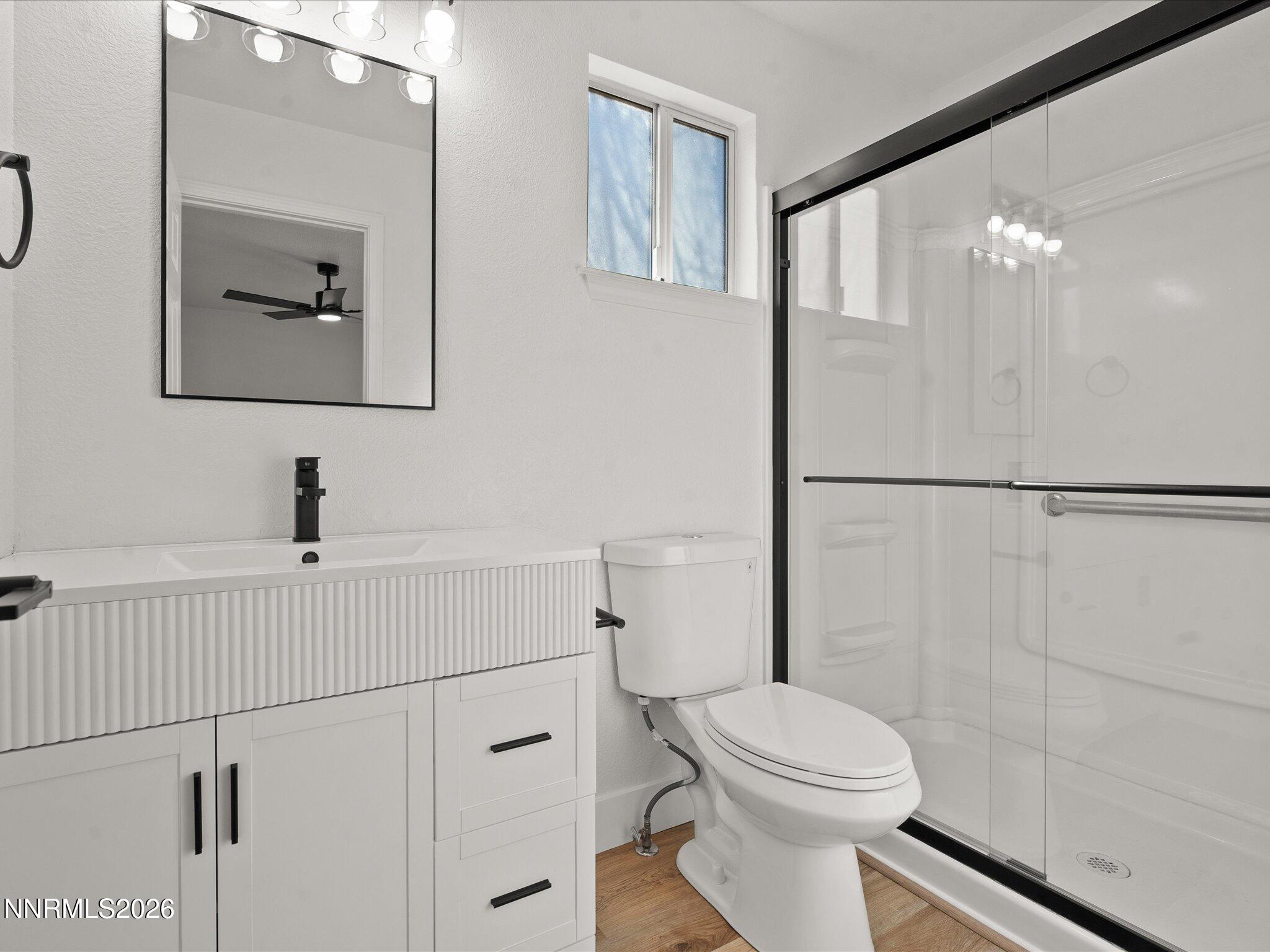 3549 Shadow Lane Carson City, NV 89705 - Photo 16 of 32 a bathroom with a toilet a sink and mirror