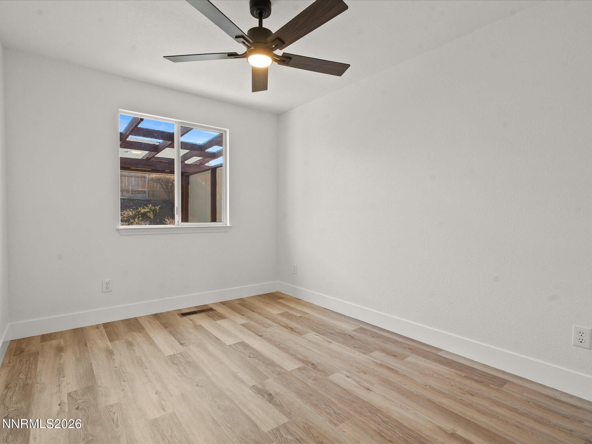 3549 Shadow Lane Carson City, NV 89705 - Photo 20 of 32 wooden floor in an empty room with a window