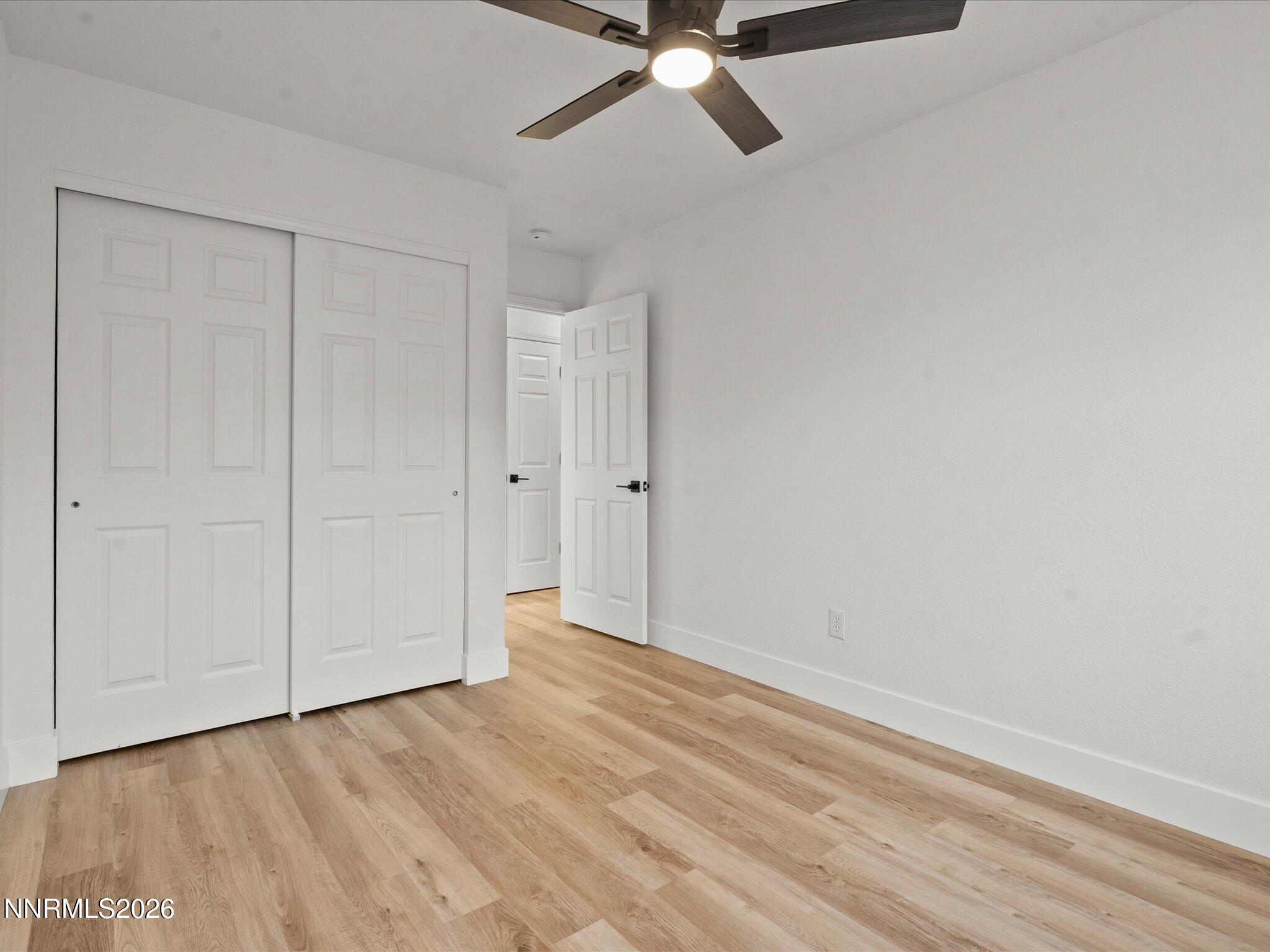 3549 Shadow Lane Carson City, NV 89705 - Photo 21 of 32 a view of a room with wooden floor and white walls