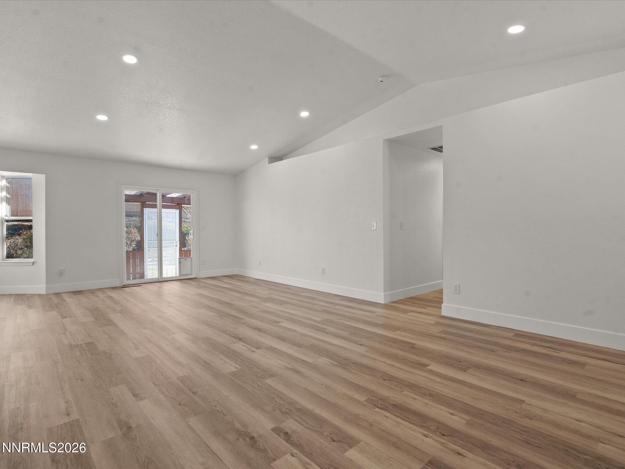 3549 Shadow Lane Carson City, NV 89705 - Photo 4 of 32 a view of empty room with wooden floor and fan