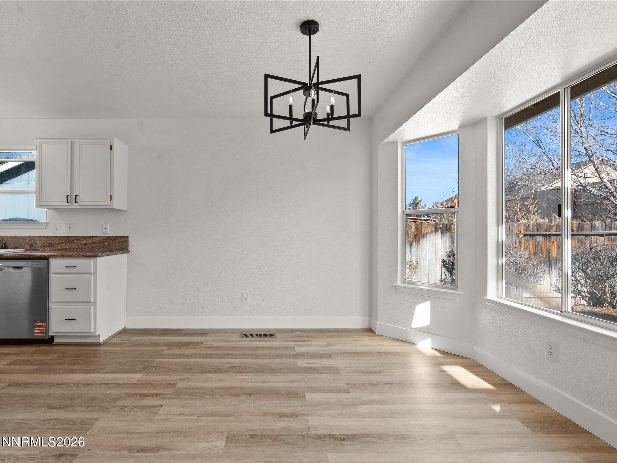 3549 Shadow Lane Carson City, NV 89705 - Photo 7 of 32 a view of a room with wooden floor and windows