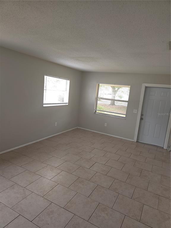 1741 Trotter Road, Unit A Largo, FL 33774 - Photo 2 of 9 an empty room with windows