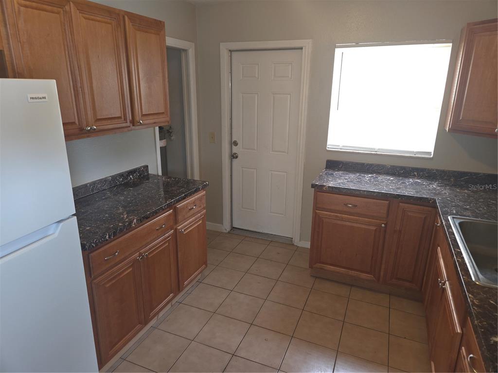 1741 Trotter Road, Unit A Largo, FL 33774 - Photo 4 of 9 a kitchen with a sink cabinets and a window
