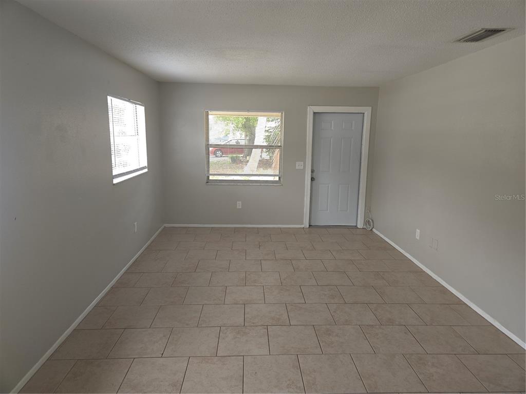 1741 Trotter Road, Unit A Largo, FL 33774 - Photo 5 of 9 a view of an empty room with a window