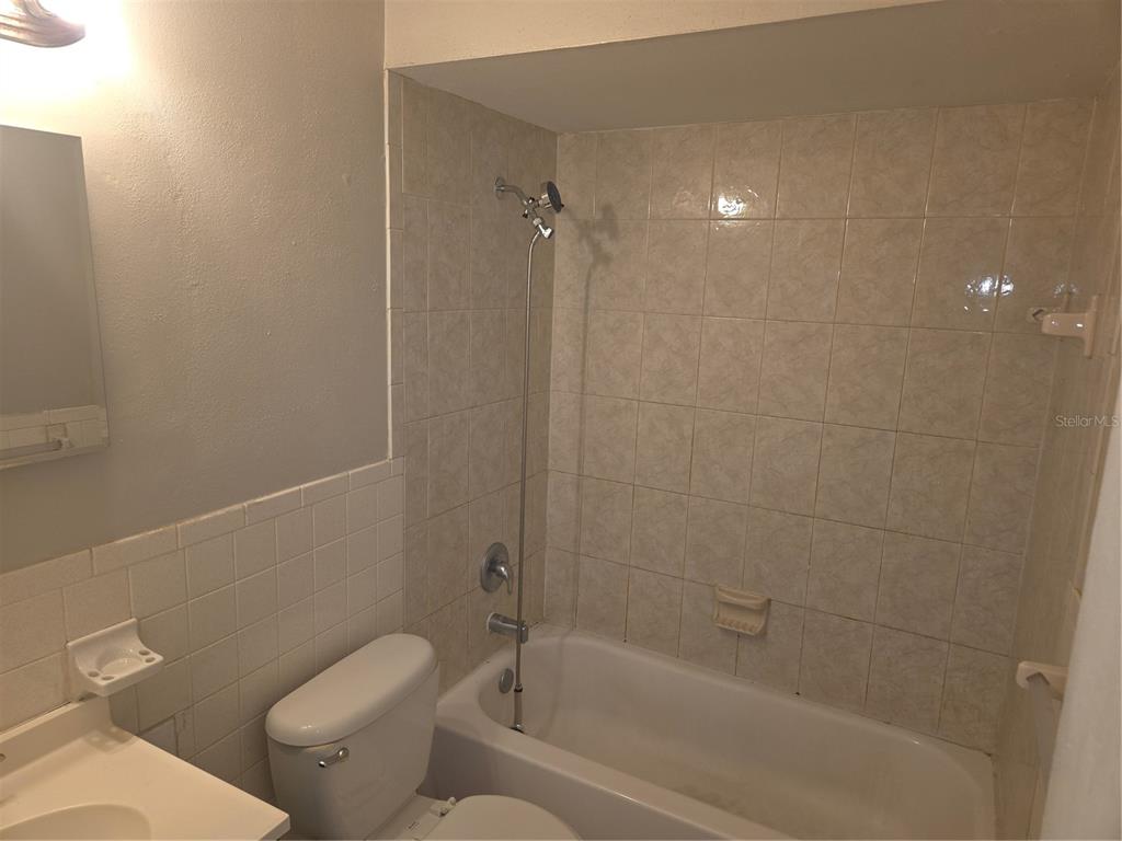 1741 Trotter Road, Unit A Largo, FL 33774 - Photo 7 of 9 a bathroom with a toilet and shower