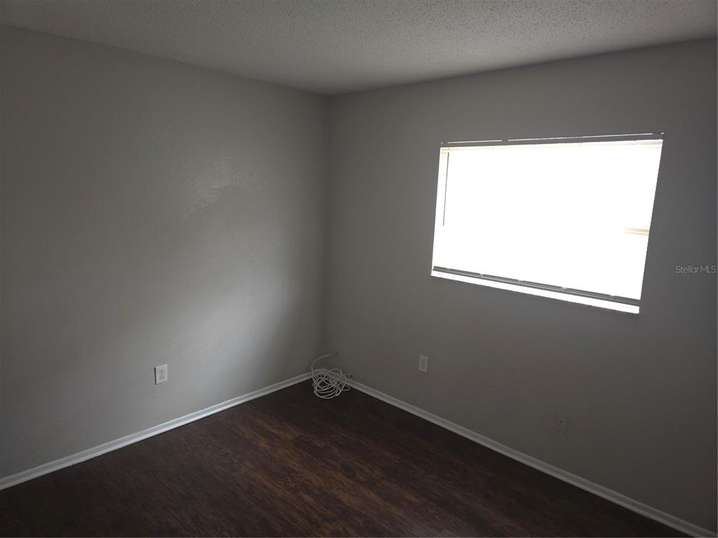 1741 Trotter Road, Unit A Largo, FL 33774 - Photo 8 of 9 an empty room with a window