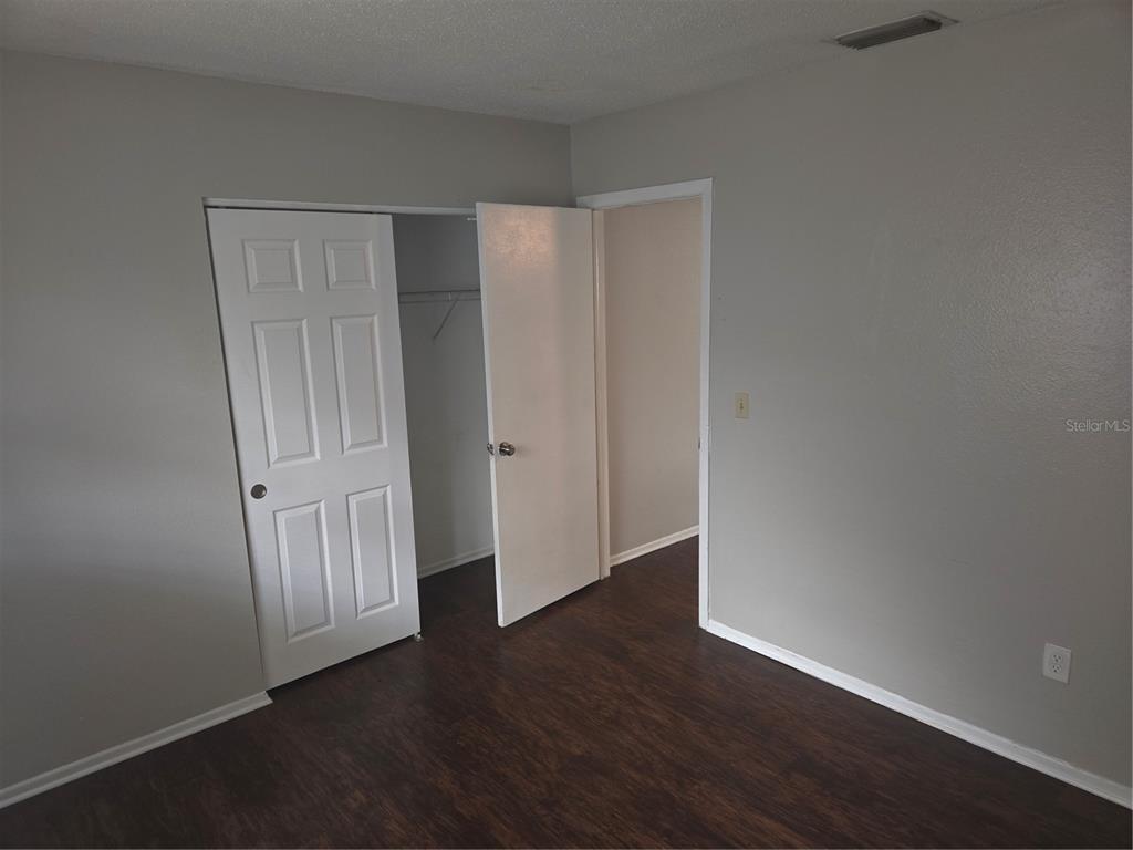 1741 Trotter Road, Unit A Largo, FL 33774 - Photo 9 of 9 a view of empty room with wooden floor and entryway