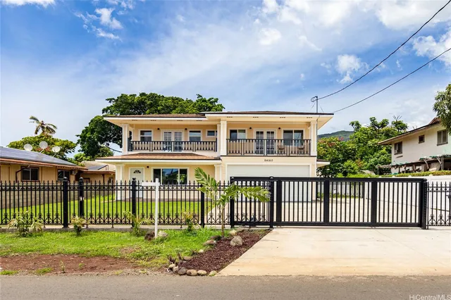 a front view of a building with a garden and deck