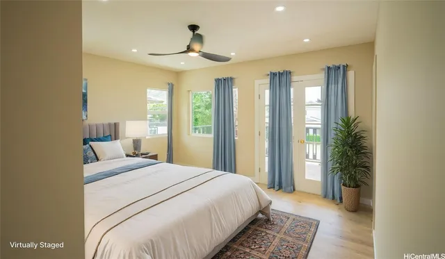 a bedroom with a large bed and a chandelier