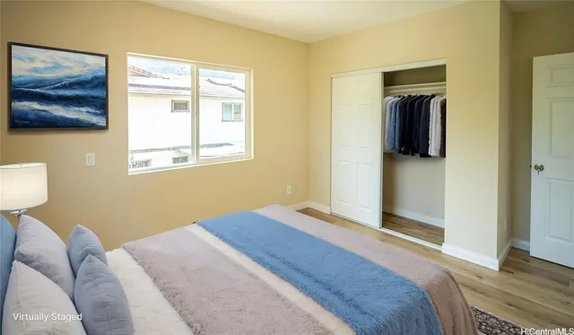a bedroom with a bed and a painting on the wall