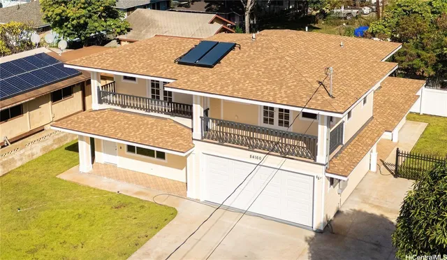 an aerial view of a house with a swimming pool