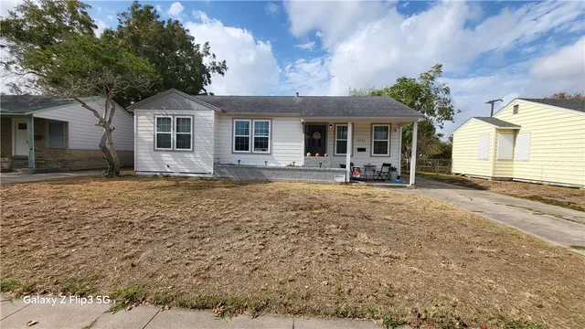 a front view of a house with yard and seating space