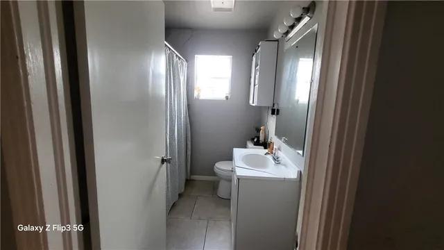a bathroom with a sink a mirror and a toilet