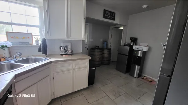 a room with sink and cabinets