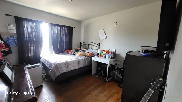 a bedroom with a bed closet and a window