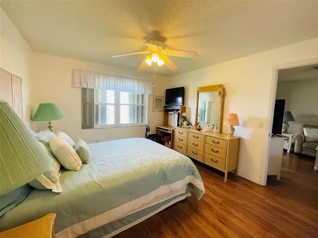 a bed room with a bed window and a television