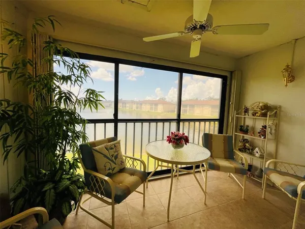 a living room with a large window and furniture