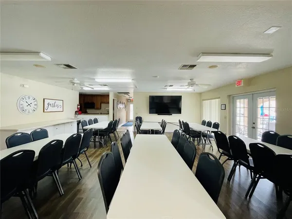 a living room with furniture kitchen view and a flat screen tv