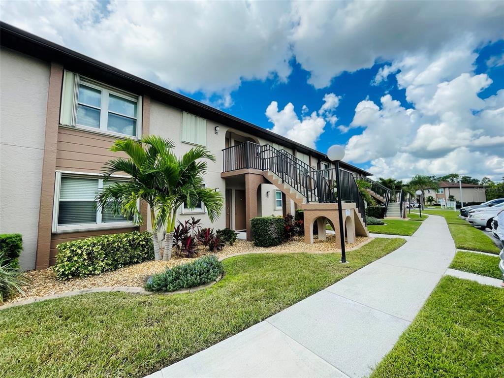 25100 Sandhill Boulevard, Unit Q201 Punta Gorda, FL 33983 - Photo 2 of 25 a view of a house with a yard