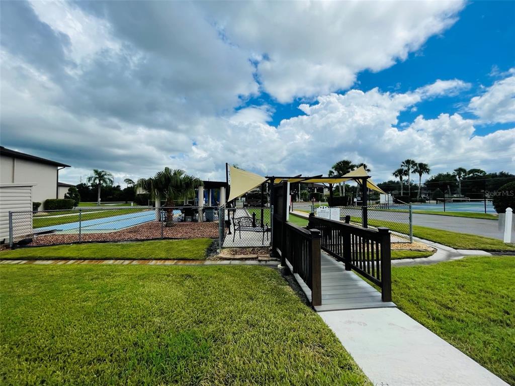 25100 Sandhill Boulevard, Unit Q201 Punta Gorda, FL 33983 - Photo 22 of 25 a view of a swimming pool with a yard