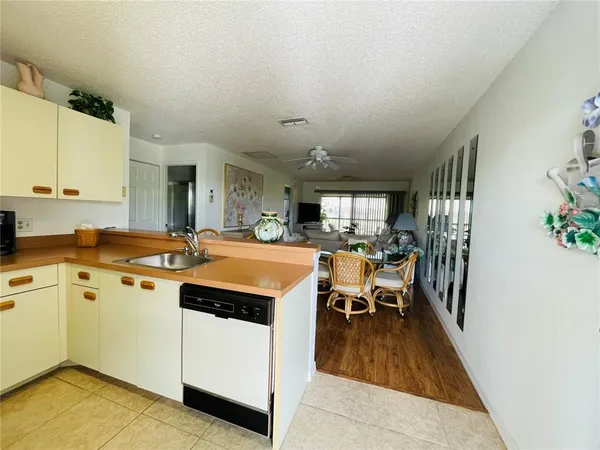 a kitchen with a sink and wooden floor
