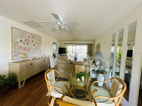 a view of a dining room with furniture window and wooden floor