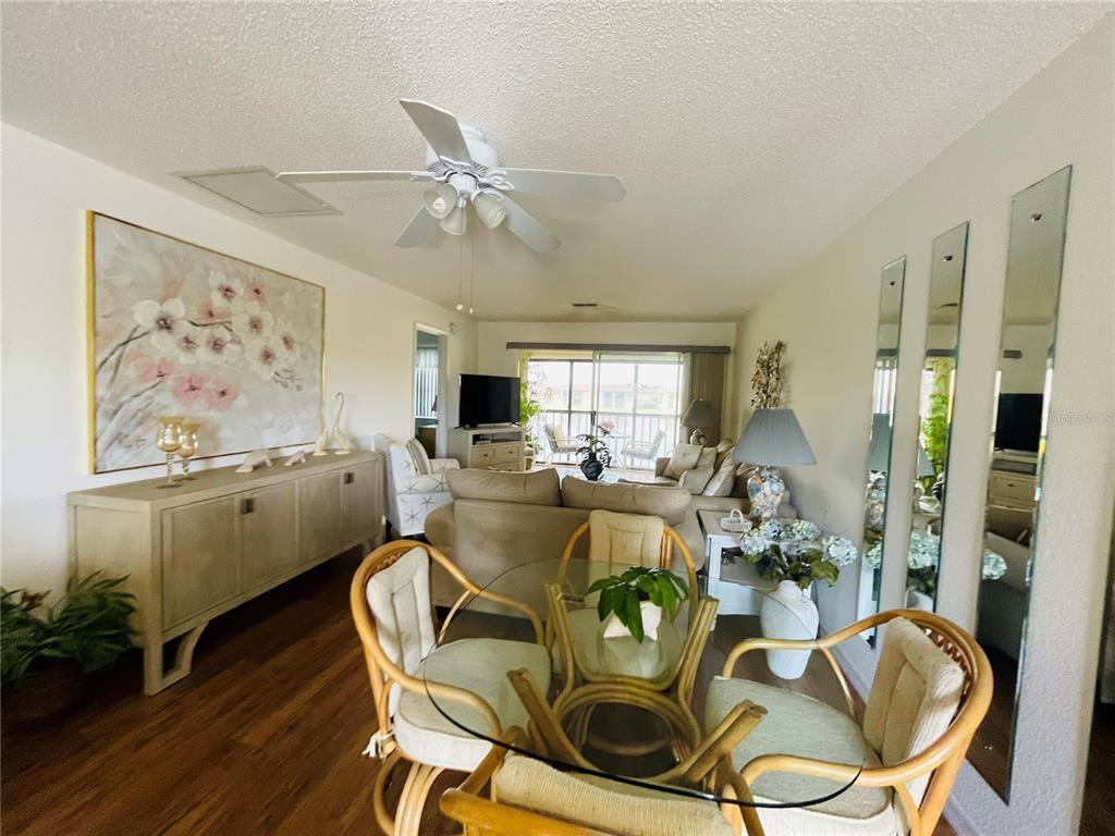 25100 Sandhill Boulevard, Unit Q201 Punta Gorda, FL 33983 - Photo 4 of 25 a view of a dining room with furniture window and wooden floor