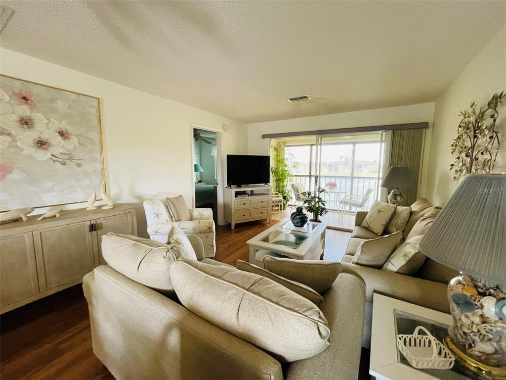 25100 Sandhill Boulevard, Unit Q201 Punta Gorda, FL 33983 - Photo 6 of 25 a living room with furniture and a flat screen tv