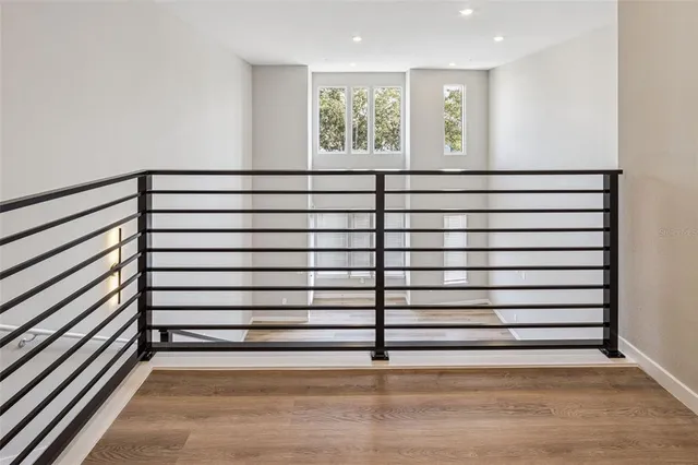 a view of a room with a white wall and a window