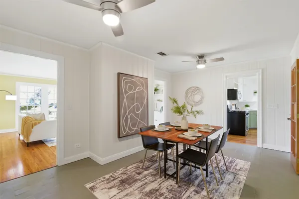 a view of a dining room with furniture and wooden floor