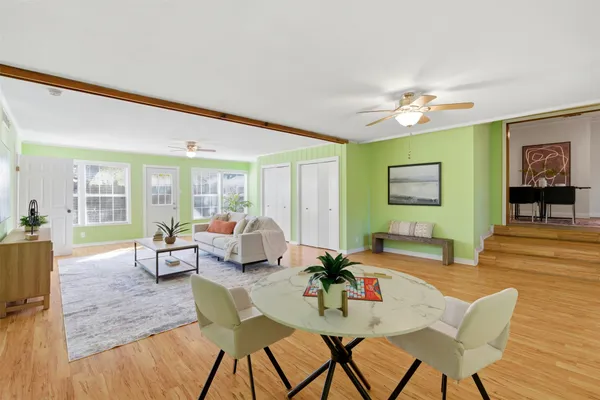 a living room with furniture and wooden floor